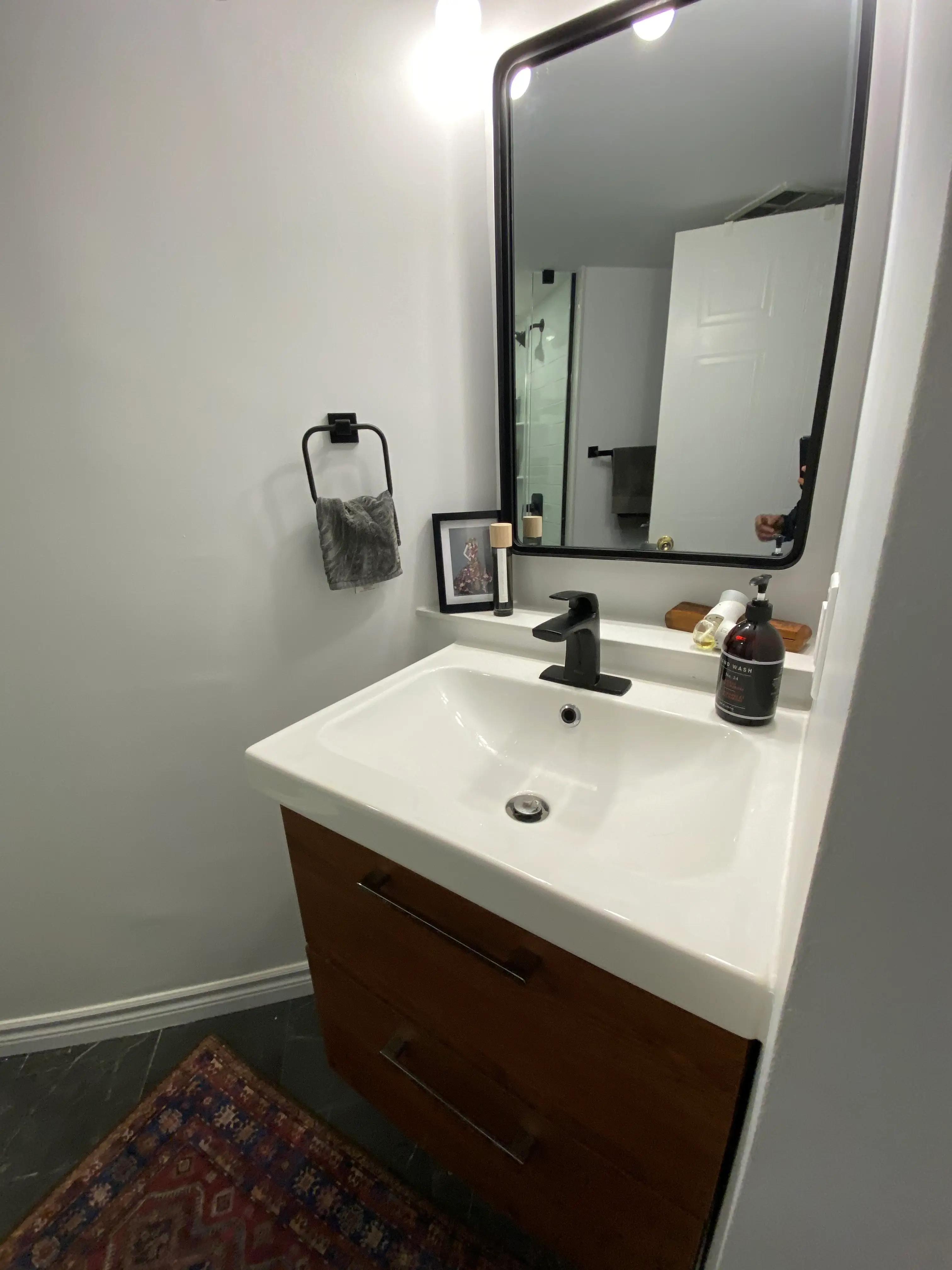 Completed bathroom renovation with custom vanity and tile work